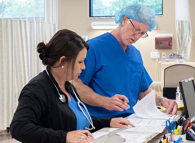 Doctor and nurse reviewing charts before surgery