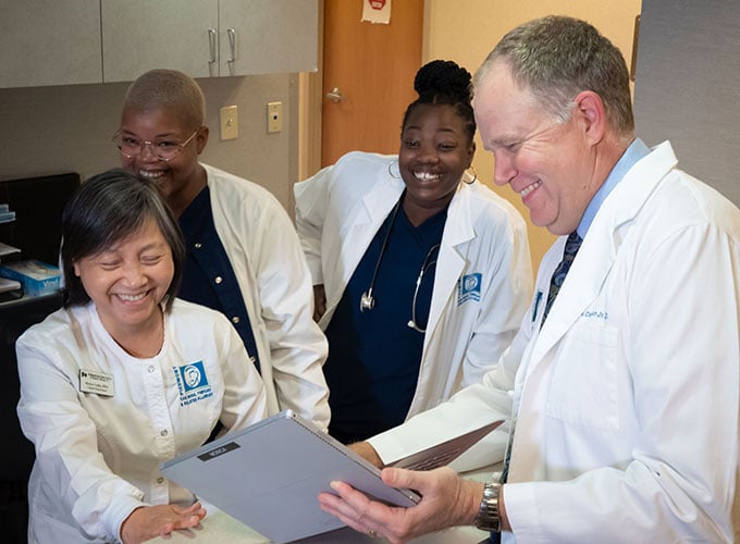 Doctor consulting with cheerful staff